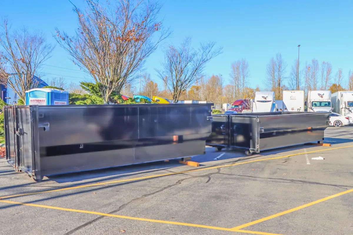 Professional dumpster rental service with roll-off container on residential driveway in Vidor